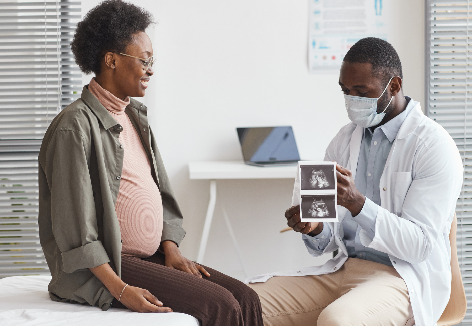 Expecting mother reviewing ultra sound pictures with doctor